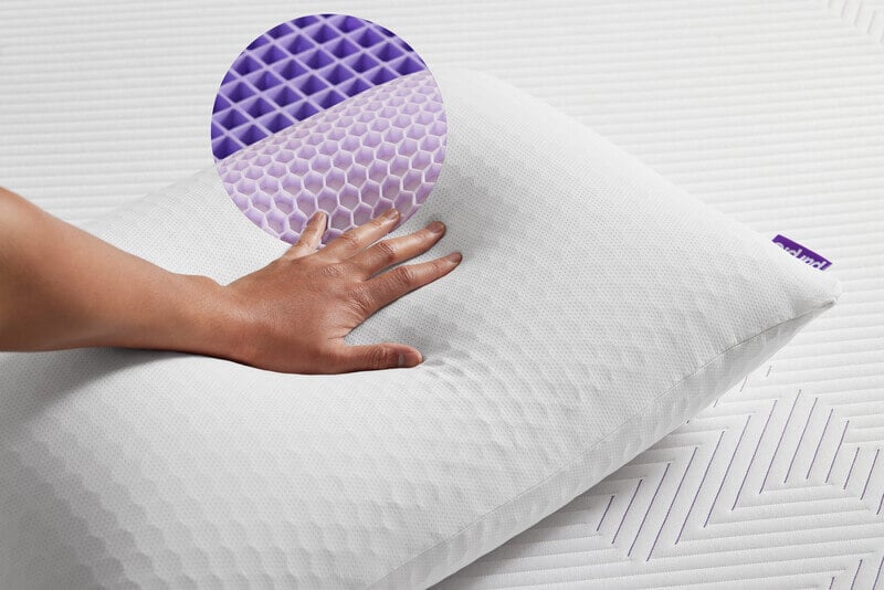 Person putting hand on Purple Harmony pillow